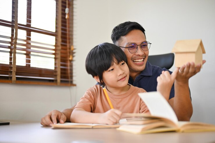 a father helping his young son with his homework at home