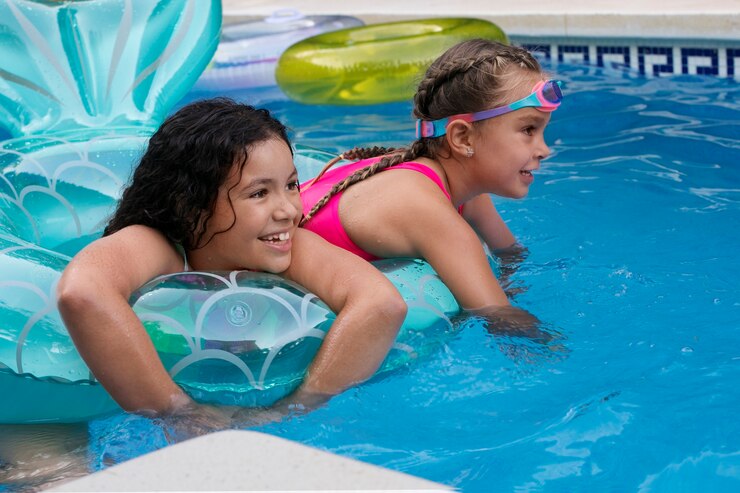 children enjoying a swimming class in a pool