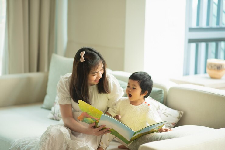 a mother reading a book to her daughter