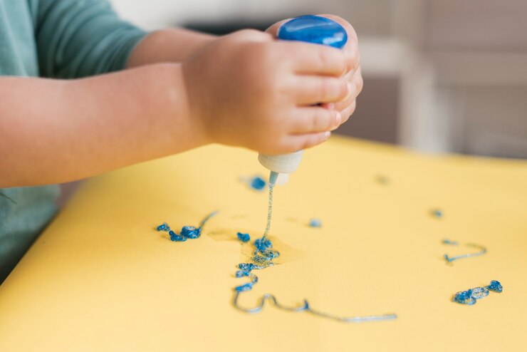a child pouring glue to make slime