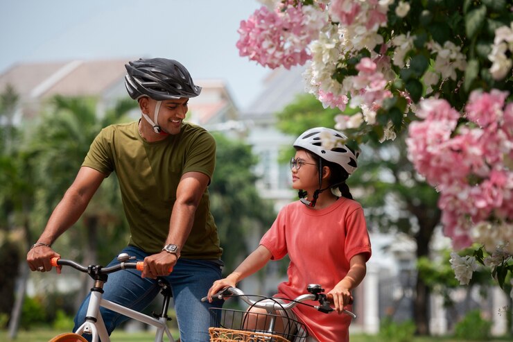 a child cycling outdoors with their parents
