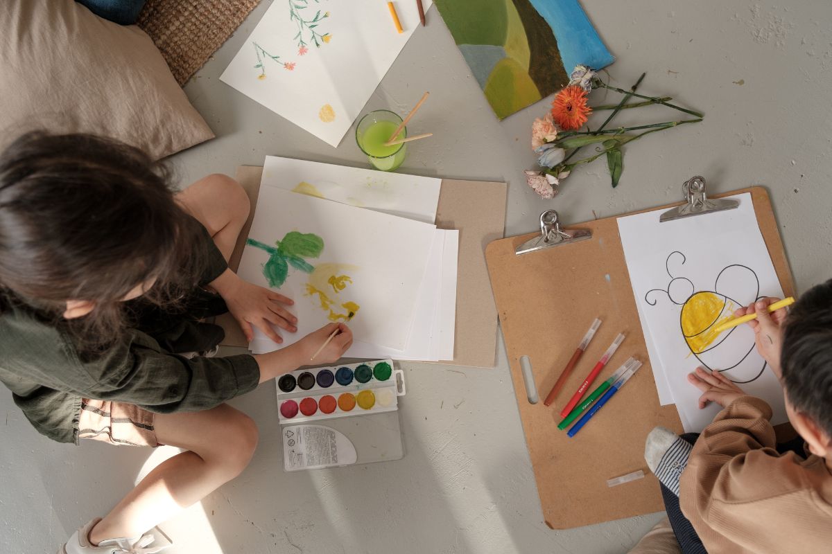 a child making art with support from a parent